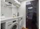 Bright laundry room with washer, dryer, and ample shelving at 2575 Peachtree Ne Rd # 9G, Atlanta, GA 30305