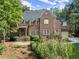 Two-story brick house with large windows and landscaping at 4545 Whitestone Way, Suwanee, GA 30024