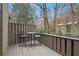 Private deck with a small table and chairs, offering wooded views at 16 Ivy Ne Rdg, Atlanta, GA 30342