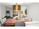 Spacious dining area with a large table, hardwood floors, and views to the living room and balcony at 16 Ivy Ne Rdg, Atlanta, GA 30342