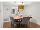 Elegant dining room with a square wooden table, gray chairs, and a gold light fixture at 16 Ivy Ne Rdg, Atlanta, GA 30342