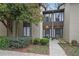 Tan colored exterior of a townhome with manicured landscaping and walkway at 16 Ivy Ne Rdg, Atlanta, GA 30342