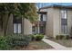 Tan colored exterior of a townhome with manicured landscaping and walkway at 16 Ivy Ne Rdg, Atlanta, GA 30342
