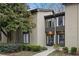 Tan colored exterior of a townhome with manicured landscaping and walkway at 16 Ivy Ne Rdg, Atlanta, GA 30342