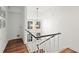Bright hallway with hardwood floors and modern light fixture at 16 Ivy Ne Rdg, Atlanta, GA 30342