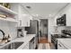 Modern kitchen with white cabinets, marble countertops, and stainless steel appliances at 16 Ivy Ne Rdg, Atlanta, GA 30342