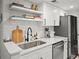 Modern kitchen with white cabinets, marble countertops, and a stainless steel sink at 16 Ivy Ne Rdg, Atlanta, GA 30342