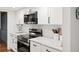 Modern kitchen with white cabinets, marble countertops, and stainless steel appliances at 16 Ivy Ne Rdg, Atlanta, GA 30342