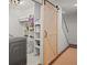 Basement laundry area with barn door and shelving at 16 Ivy Ne Rdg, Atlanta, GA 30342