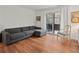 Living room with sectional sofa, hardwood floors, and access to balcony at 16 Ivy Ne Rdg, Atlanta, GA 30342