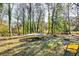Large backyard with trampoline, mature trees and a wooded backdrop at 2508 Connally Dr, East Point, GA 30344