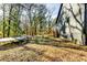 Spacious backyard with a deck and trampoline, backing to wooded area at 2508 Connally Dr, East Point, GA 30344