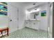 Clean bathroom with double vanity, green tile floor and big mirror at 2508 Connally Dr, East Point, GA 30344
