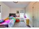 Bright bedroom featuring a twin-sized bed, dresser and window at 2508 Connally Dr, East Point, GA 30344