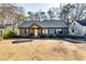 Charming craftsman style home with gray siding, modern door, and landscaped yard at 2508 Connally Dr, East Point, GA 30344