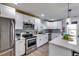 Modern kitchen featuring white cabinets, stainless steel appliances, and an island at 2508 Connally Dr, East Point, GA 30344
