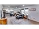 Open concept living room with kitchen view, hardwood floors, and stylish furniture at 2508 Connally Dr, East Point, GA 30344