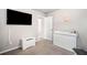 Bright bedroom with modern décor, a mounted TV, and clean white furnishings, creating a serene atmosphere at 319 Pinewood Dr, Woodstock, GA 30189