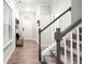 Hallway with staircase and bench in the entry of the home at 319 Pinewood Dr, Woodstock, GA 30189