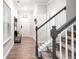 Welcoming foyer with stylish wood flooring, a staircase, and ample natural light at 319 Pinewood Dr, Woodstock, GA 30189