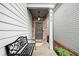Inviting front entrance with stone accents, house numbers, and a cozy bench at 319 Pinewood Dr, Woodstock, GA 30189
