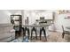 Open concept kitchen featuring granite countertops, stainless appliances, and barstool seating at 319 Pinewood Dr, Woodstock, GA 30189