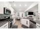 Modern kitchen with granite countertops, stainless steel appliances, and mosaic tile backsplash at 319 Pinewood Dr, Woodstock, GA 30189