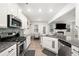 Spacious kitchen with stainless steel appliances, granite counters, and open layout to living area at 319 Pinewood Dr, Woodstock, GA 30189
