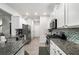Well-lit kitchen with granite counters, stainless steel appliances, and mosaic tile backsplash at 319 Pinewood Dr, Woodstock, GA 30189