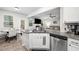 Bright kitchen showcasing stainless steel appliances, granite counters, and eat-in breakfast area at 319 Pinewood Dr, Woodstock, GA 30189