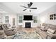 Open-concept living room with fireplace, ceiling fan, and hardwood floors at 319 Pinewood Dr, Woodstock, GA 30189