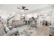 Open-concept living room with fireplace, ceiling fan, and hardwood floors at 319 Pinewood Dr, Woodstock, GA 30189