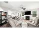 Open-concept living room with fireplace, ceiling fan, and hardwood floors at 319 Pinewood Dr, Woodstock, GA 30189