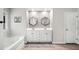 Serene main bathroom with double vanity, soaking tub, and stylish mirrors at 319 Pinewood Dr, Woodstock, GA 30189