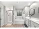 Bright main bathroom with a glass shower, soaking tub, double vanity, and modern finishes at 319 Pinewood Dr, Woodstock, GA 30189