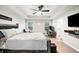 Bright bedroom with a tray ceiling, a ceiling fan, and a home office setup at 319 Pinewood Dr, Woodstock, GA 30189