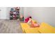 A playroom with grey carpet, white walls, and a variety of toys and furniture, ideal for Gathering fun at 319 Pinewood Dr, Woodstock, GA 30189