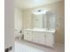 Bathroom with double vanity, large mirror, and white tile flooring at 790 Oakhaven Dr, Roswell, GA 30075