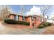 Brick house with landscaping and a long driveway at 790 Oakhaven Dr, Roswell, GA 30075