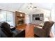 Spacious living room features hardwood floors, a brick fireplace, and built-in shelving at 790 Oakhaven Dr, Roswell, GA 30075