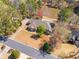 Stunning aerial view of estate home with in-ground pool and lake access surrounded by lush trees on large lot at 19 Spring Lake Ne Trl, White, GA 30184