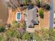 A beautiful lakefront home featuring a large backyard swimming pool and lush surrounding greenery at 19 Spring Lake Trl, White, GA 30184