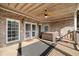Relax on this partially covered back porch with exposed brick, ceiling fan and a hot tub at 19 Spring Lake Trl, White, GA 30184