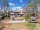 Scenic backyard view of the home featuring an in-ground pool and outdoor gazebo at 19 Spring Lake Trl, White, GA 30184