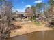A lush backyard featuring a pool, a gazebo, and decks overlooking a peaceful body of water at 19 Spring Lake Trl, White, GA 30184