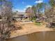 Lake view of a property featuring a swimming pool, gazebo, and stairs leading down to the lake at 19 Spring Lake Trl, White, GA 30184