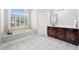 Bright bathroom with soaking tub, granite counters, and dark wood cabinetry at 19 Spring Lake Trl, White, GA 30184