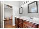 Bathroom featuring a double sink vanity and a doorway leading to an adjoining bedroom at 19 Spring Lake Trl, White, GA 30184