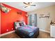 Fun bedroom with a bright accent wall, hardwood floors, and fun decor at 19 Spring Lake Trl, White, GA 30184