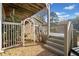 Exterior view of a deck with an arbor, stairs, and lush trees on the property at 19 Spring Lake Trl, White, GA 30184